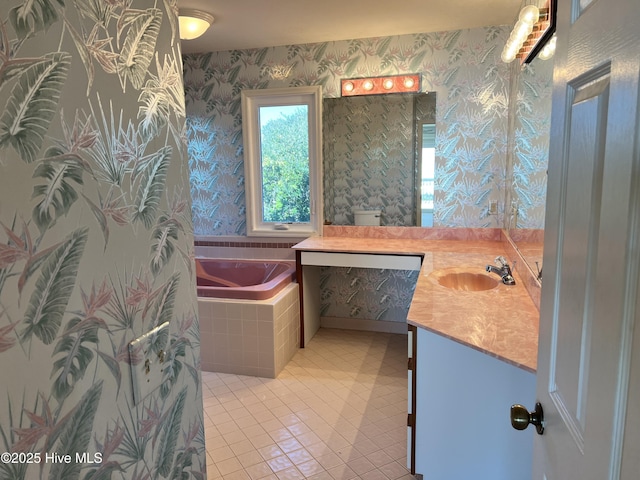 bathroom with vanity, tiled tub, and tile patterned flooring