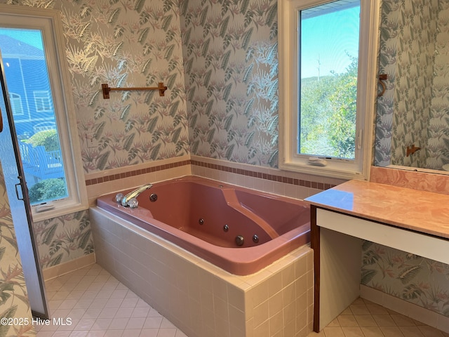 bathroom with tile patterned floors, vanity, and tiled tub