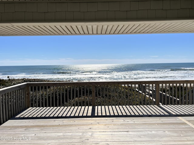 deck with a beach view and a water view