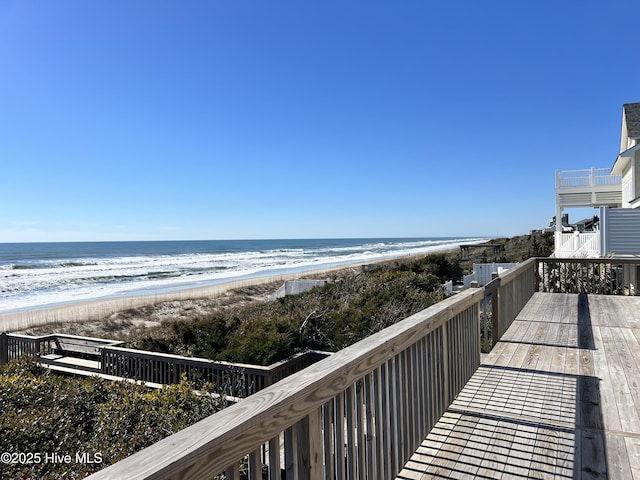 view of community featuring a water view and a beach view