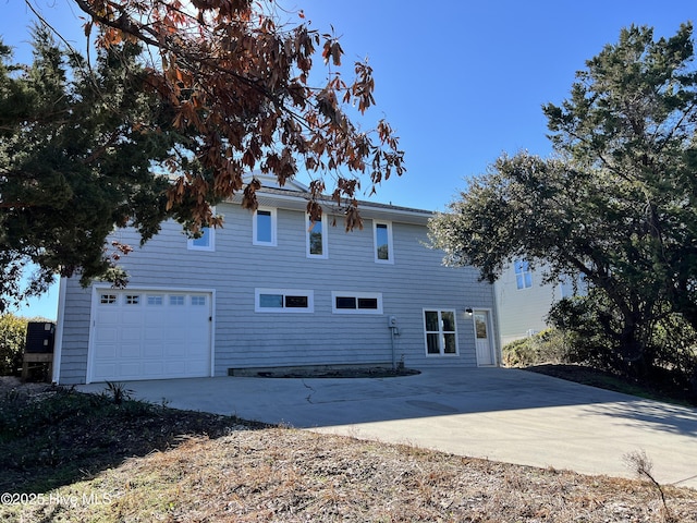 back of house with a garage