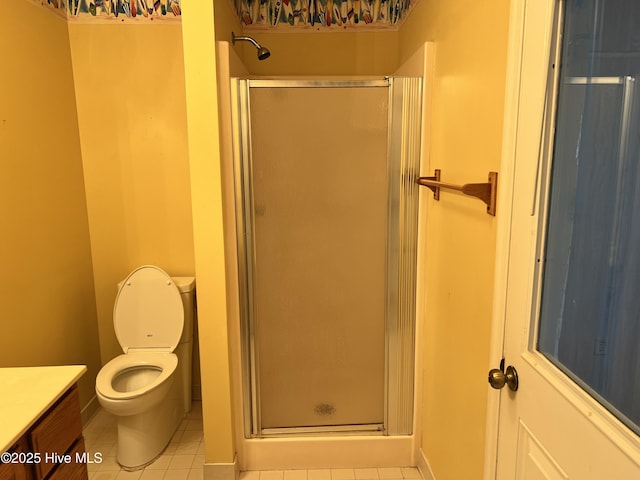 bathroom with tile patterned flooring, vanity, toilet, and walk in shower