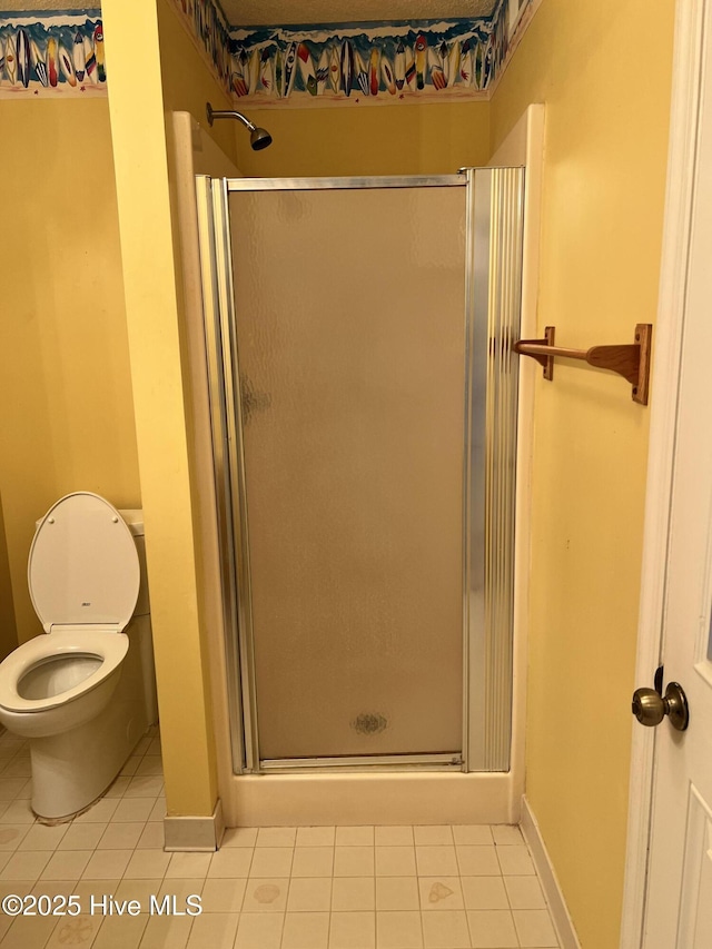 bathroom featuring tile patterned flooring, an enclosed shower, and toilet