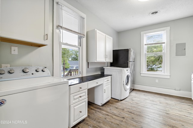 clothes washing area with washer / clothes dryer, visible vents, plenty of natural light, and light wood-style flooring