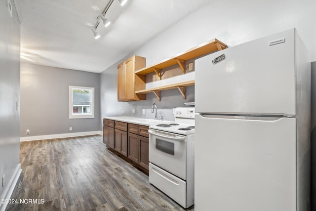 kitchen with white appliances, wood finished floors, a sink, baseboards, and open shelves