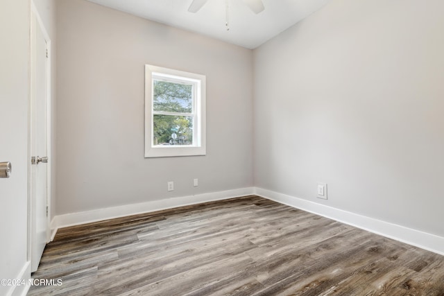 unfurnished room with a ceiling fan, baseboards, and wood finished floors