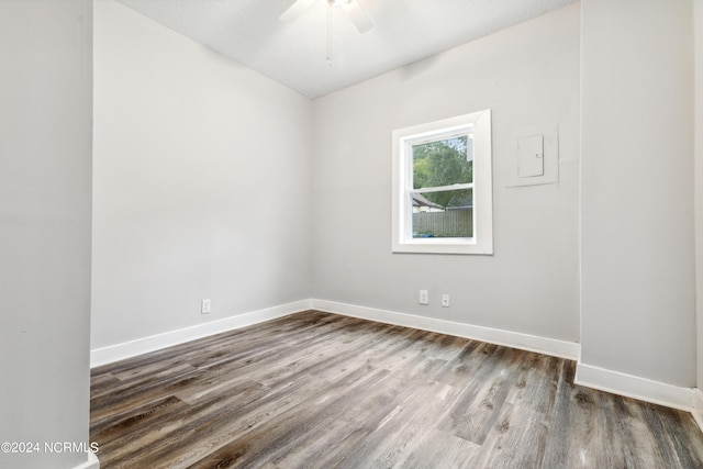 spare room with ceiling fan, wood finished floors, and baseboards