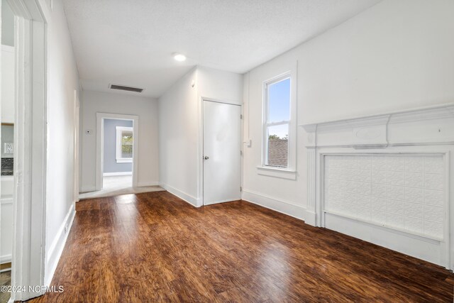 interior space featuring baseboards, visible vents, and wood finished floors