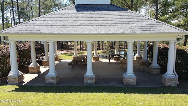 view of community featuring a yard, a patio area, and a gazebo