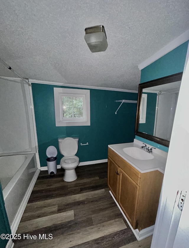 full bathroom with vanity, hardwood / wood-style floors, a textured ceiling, and toilet