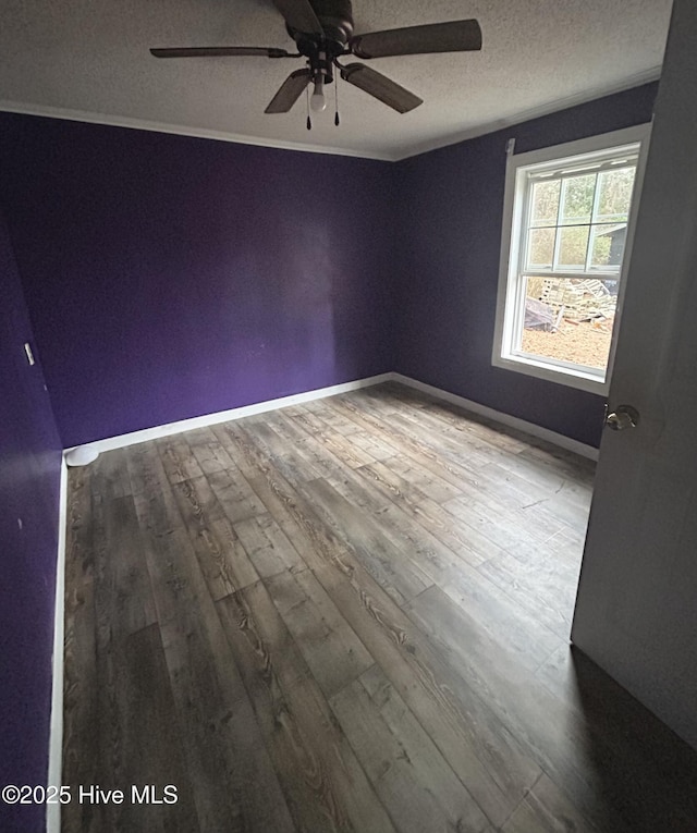 spare room with ceiling fan, wood-type flooring, and a textured ceiling