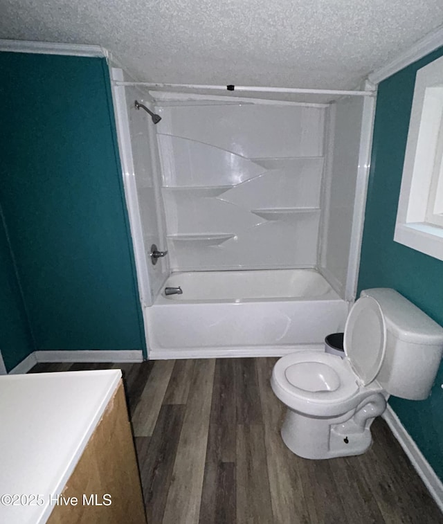 full bathroom featuring toilet, wood-type flooring, a textured ceiling, shower / tub combination, and vanity