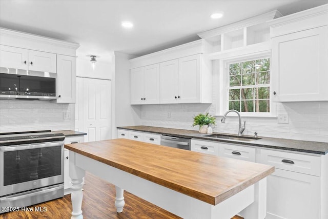 kitchen featuring stainless steel appliances, sink, and white cabinets