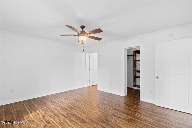 empty room with crown molding, ceiling fan, and dark hardwood / wood-style flooring