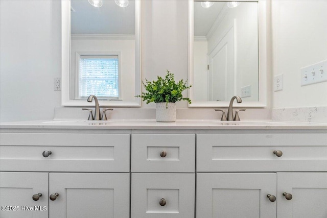 bathroom with ornamental molding and vanity