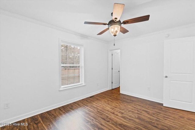 empty room featuring crown molding, dark hardwood / wood-style floors, and ceiling fan