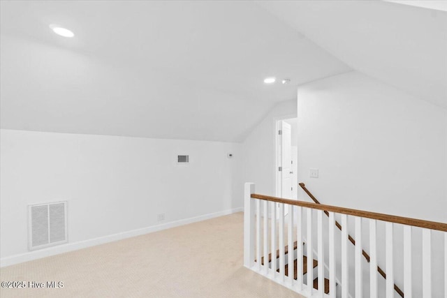 additional living space with lofted ceiling and light carpet