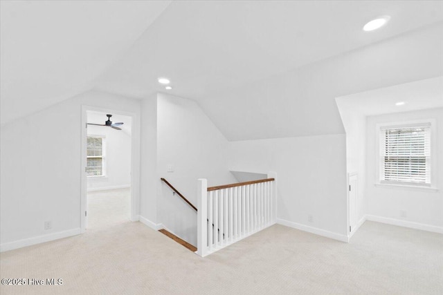 additional living space with plenty of natural light, light colored carpet, and lofted ceiling