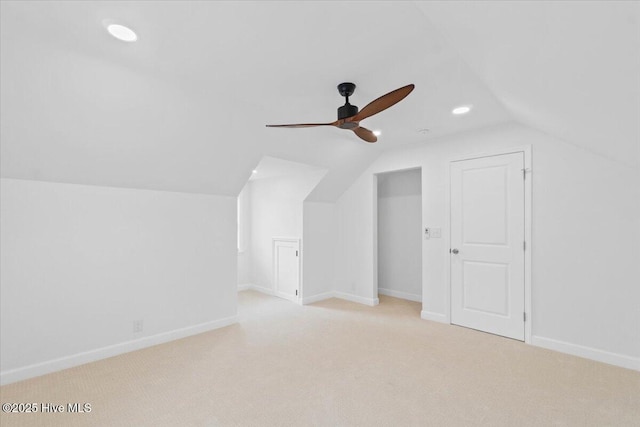 bonus room with ceiling fan, light colored carpet, and vaulted ceiling