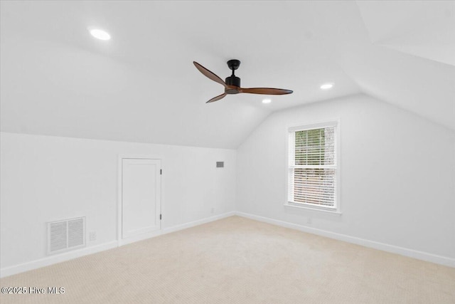 additional living space with ceiling fan, light colored carpet, and lofted ceiling