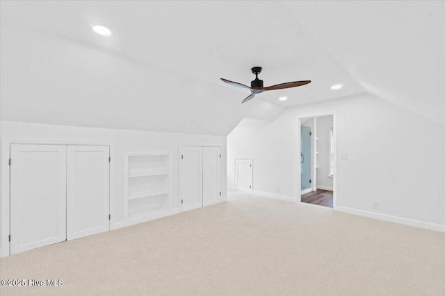 bonus room featuring ceiling fan, lofted ceiling, carpet flooring, and built in features