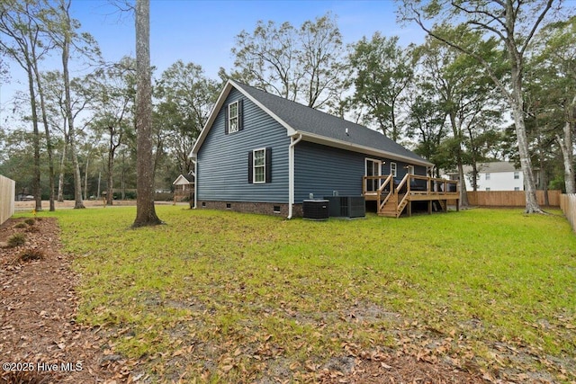 view of home's exterior with a wooden deck, a lawn, and central air condition unit