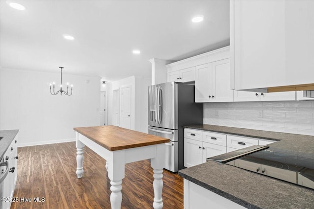 kitchen with dark wood-type flooring, white cabinetry, tasteful backsplash, decorative light fixtures, and stainless steel fridge with ice dispenser