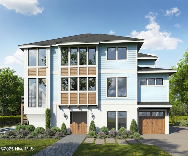 view of front facade featuring a garage, stucco siding, and aphalt driveway