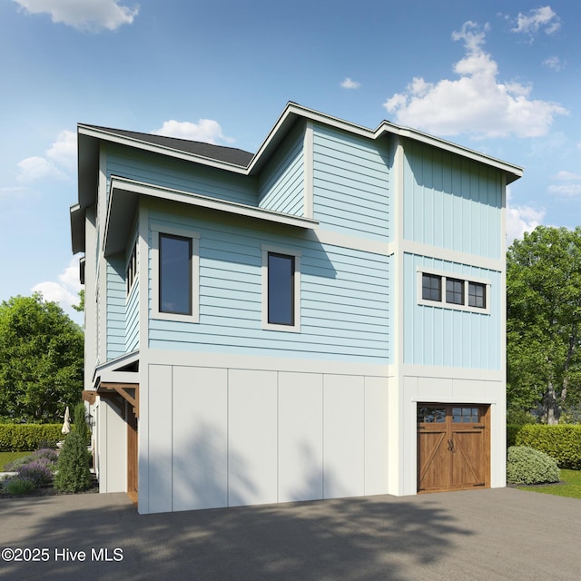 view of property exterior featuring a garage and board and batten siding