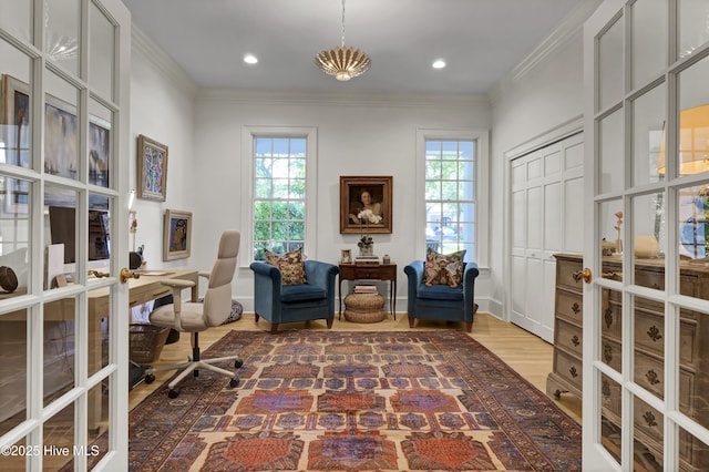 home office with crown molding, a wealth of natural light, and french doors