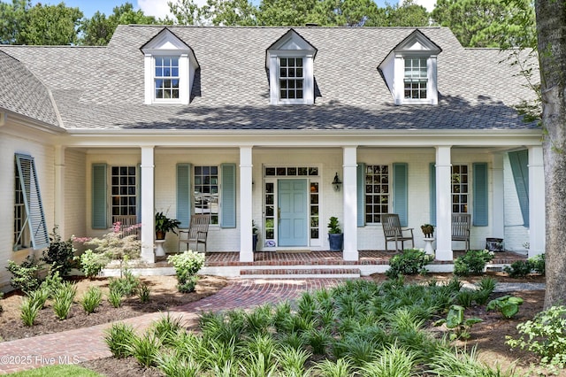 new england style home featuring covered porch