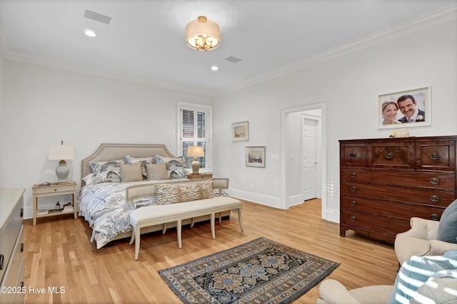 bedroom with ornamental molding and light hardwood / wood-style floors