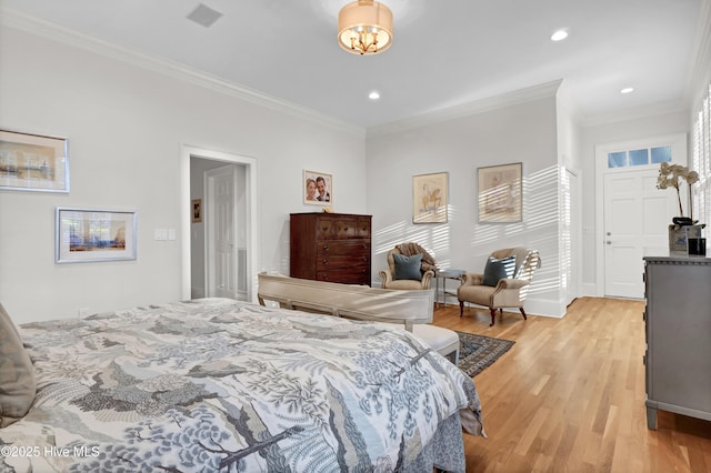 bedroom with ornamental molding and light hardwood / wood-style flooring