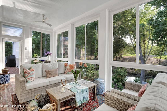 sunroom / solarium featuring ceiling fan