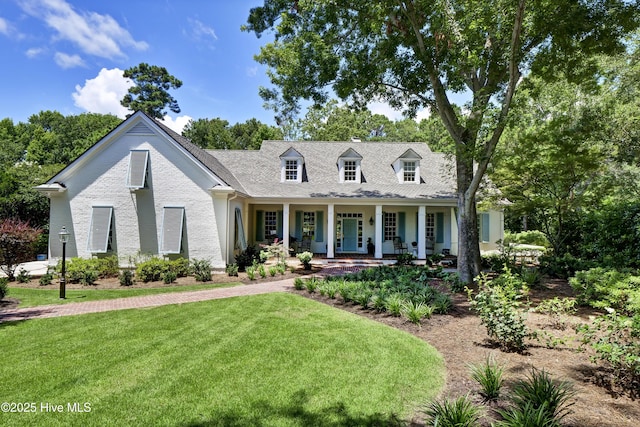 cape cod-style house featuring a porch and a front lawn