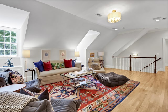 living room with lofted ceiling and wood-type flooring