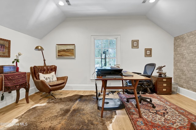 home office with lofted ceiling and light hardwood / wood-style flooring