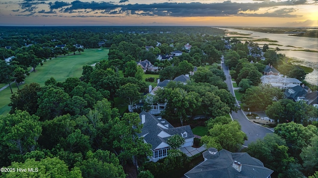 aerial view at dusk featuring a water view