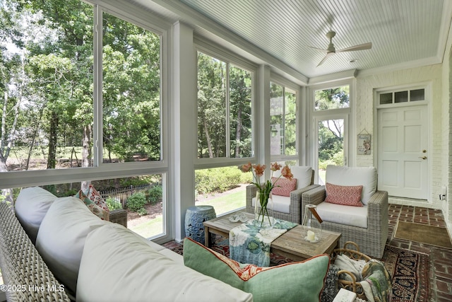 sunroom / solarium with ceiling fan and a healthy amount of sunlight