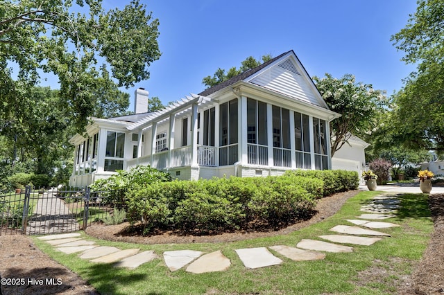 view of property exterior with a sunroom