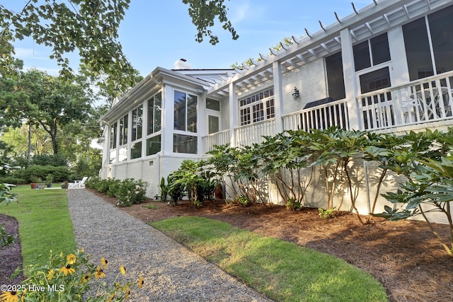 view of side of property with a sunroom