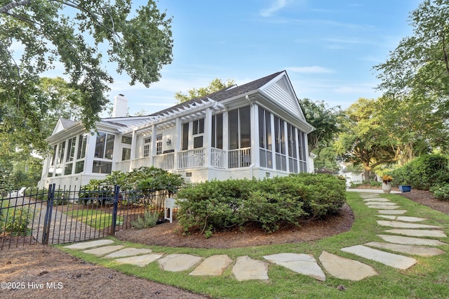 view of home's exterior featuring a sunroom