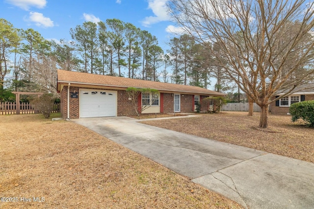 ranch-style home with a garage and a front lawn