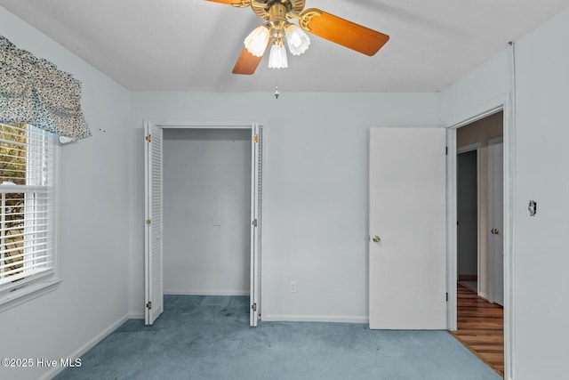 unfurnished bedroom with ceiling fan, multiple windows, and light carpet