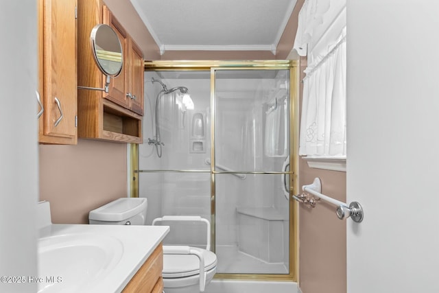 bathroom featuring vanity, ornamental molding, an enclosed shower, and toilet