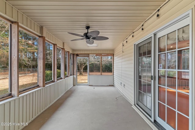 unfurnished sunroom featuring ceiling fan