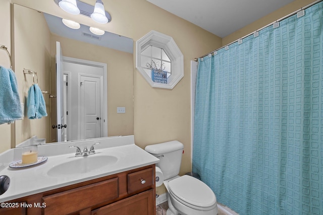 bathroom with vanity, walk in shower, and toilet