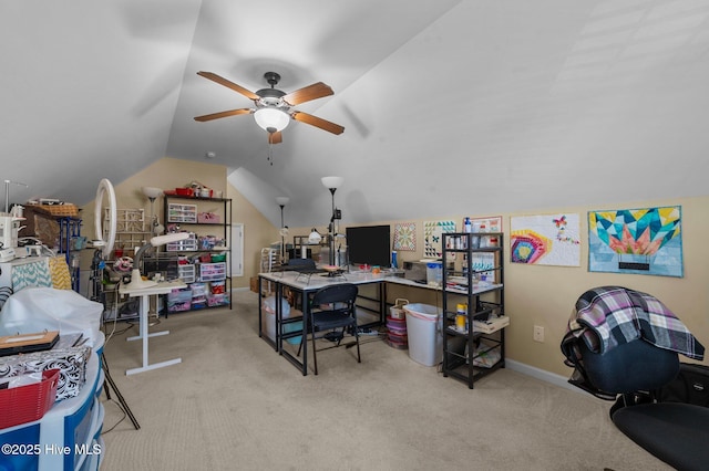 carpeted office space featuring vaulted ceiling and ceiling fan