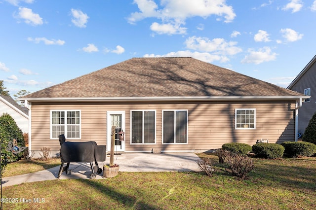 rear view of house with a patio area and a lawn