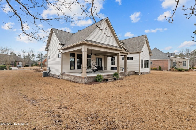 back of property featuring a lawn, central AC unit, and a patio area